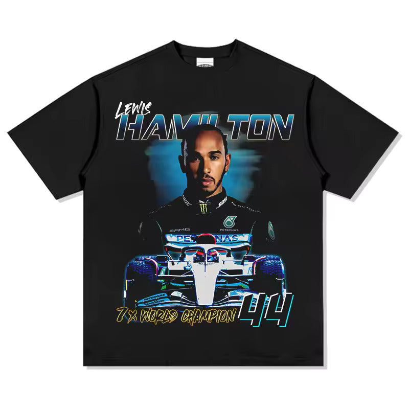 “Model wearing a Lewis Hamilton inspired loose box-fit t-shirt in a relaxed streetwear style. The t-shirt features bold, minimal race-inspired graphics on premium heavyweight cotton, with an oversized fit and dropped shoulders. Urban backdrop emphasizes a modern, confident look.”